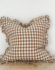 Brown gingham linen cushion with ruffled edge.