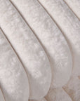 Close up of cream faux fur throw.