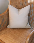 Natural rattan wicker office chair with neutral cushion.