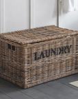 Rattan laundry basket with light and dark labels.