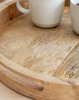 Round Wooden mango wood tray with cream mugs.