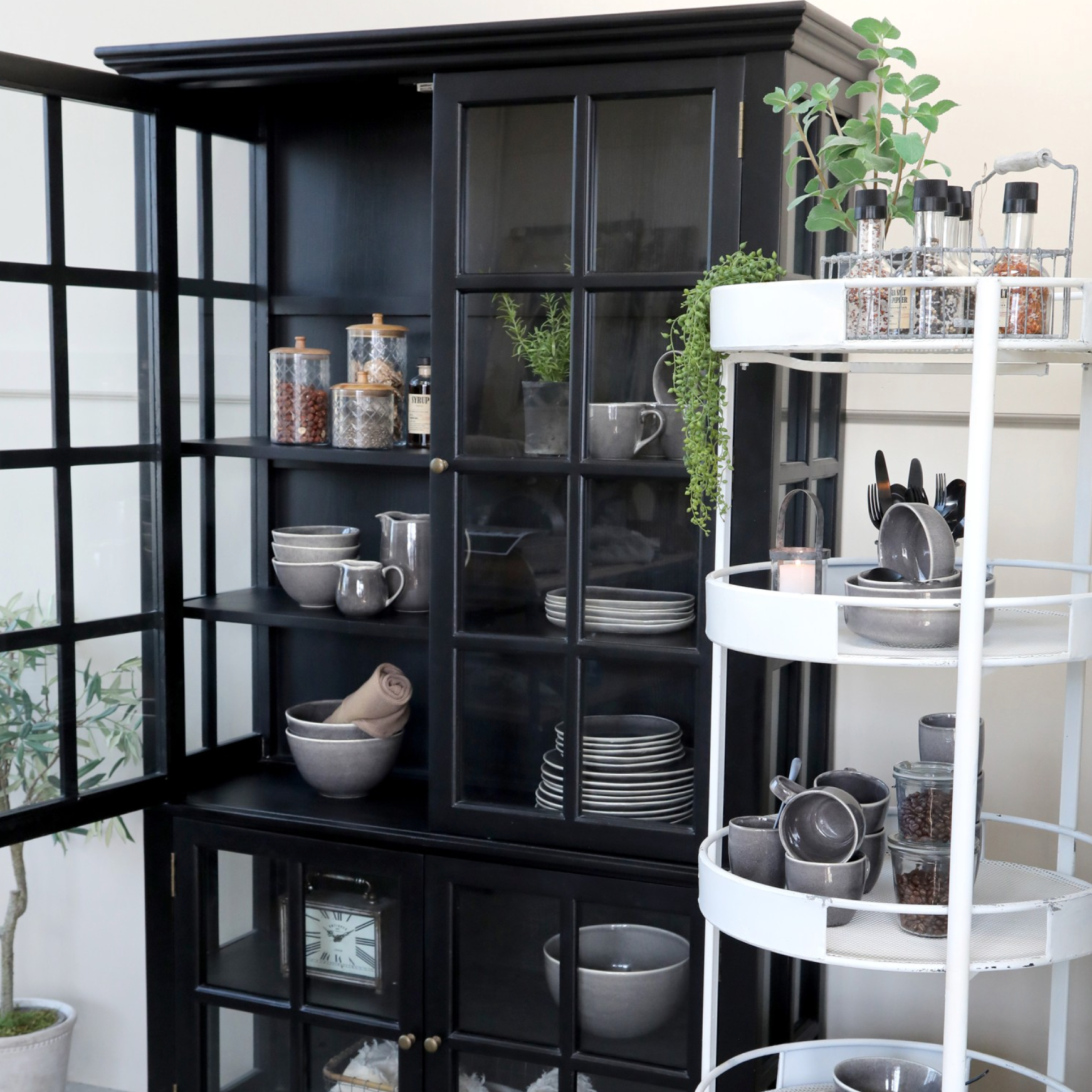 Black Armoire displaying crockery.