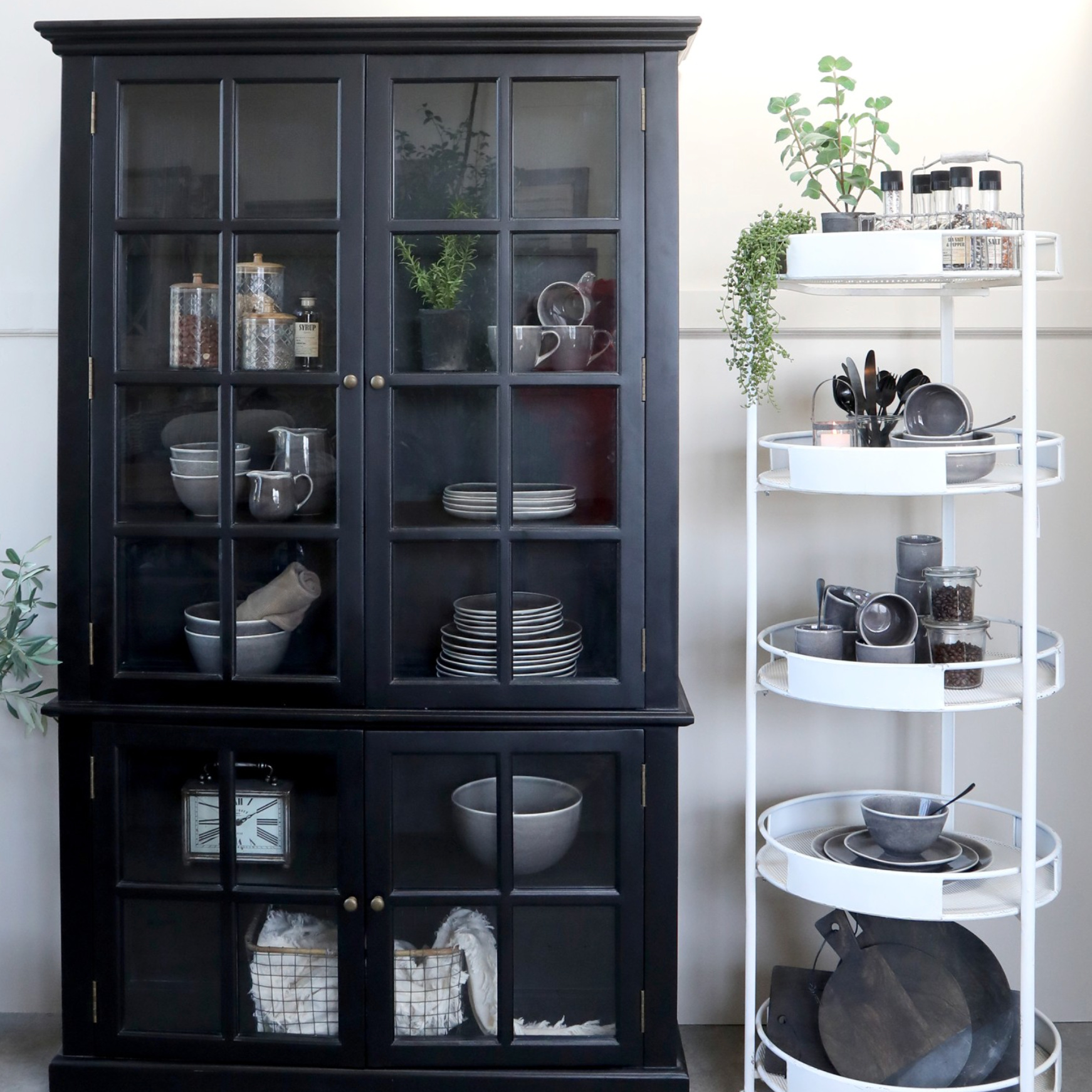 Black Armoire displaying crockery.