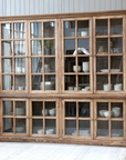 large wooden armoire displaying crockery and kitchen items.
