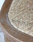 wicker seat on a wooden bar stool.