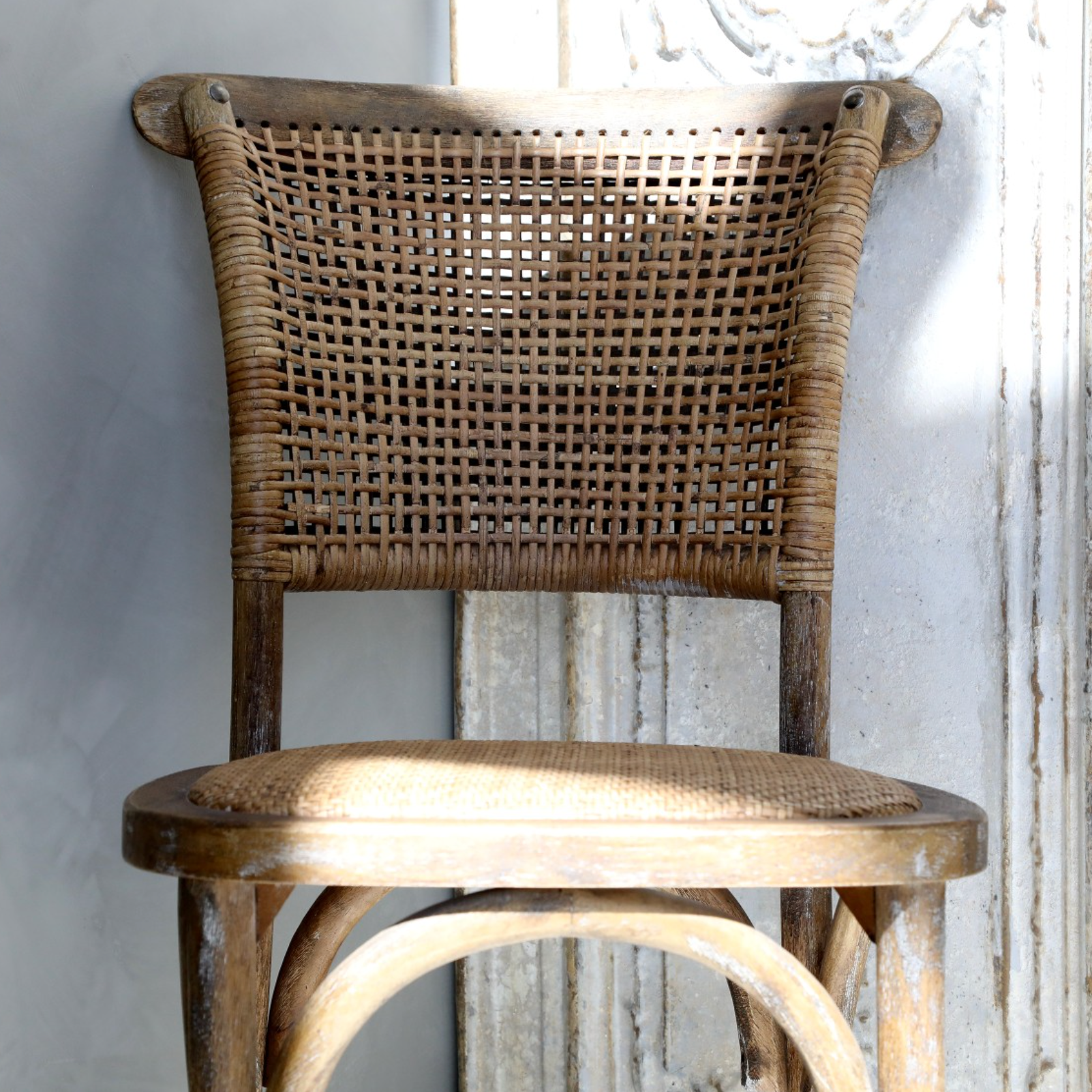 wicker dining chairs in the sunlight.