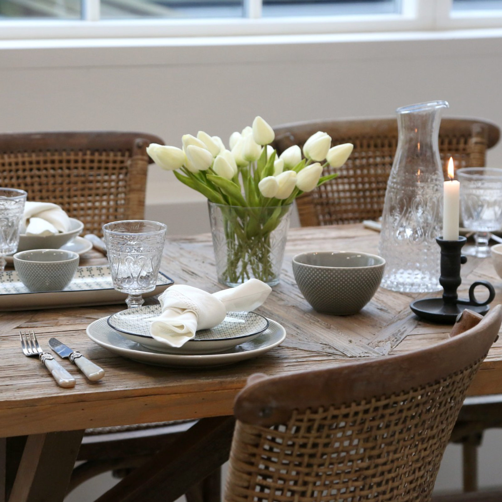 wicker dining chairs at wooden dining table.