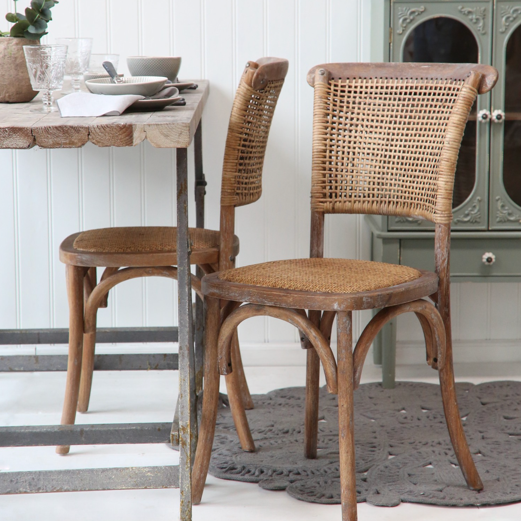 wicker dining chairs at table.
