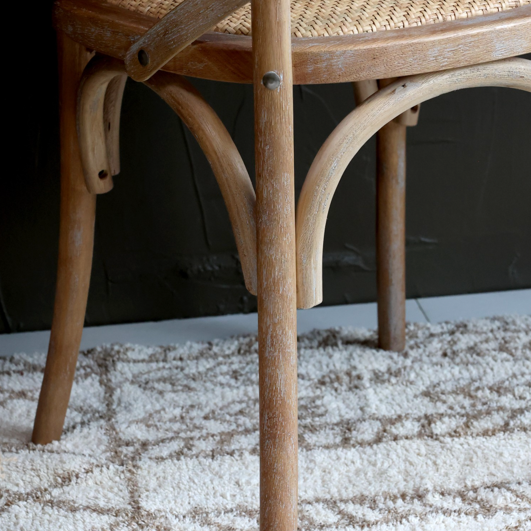 a close up image of the legs on a wooden dining chair.