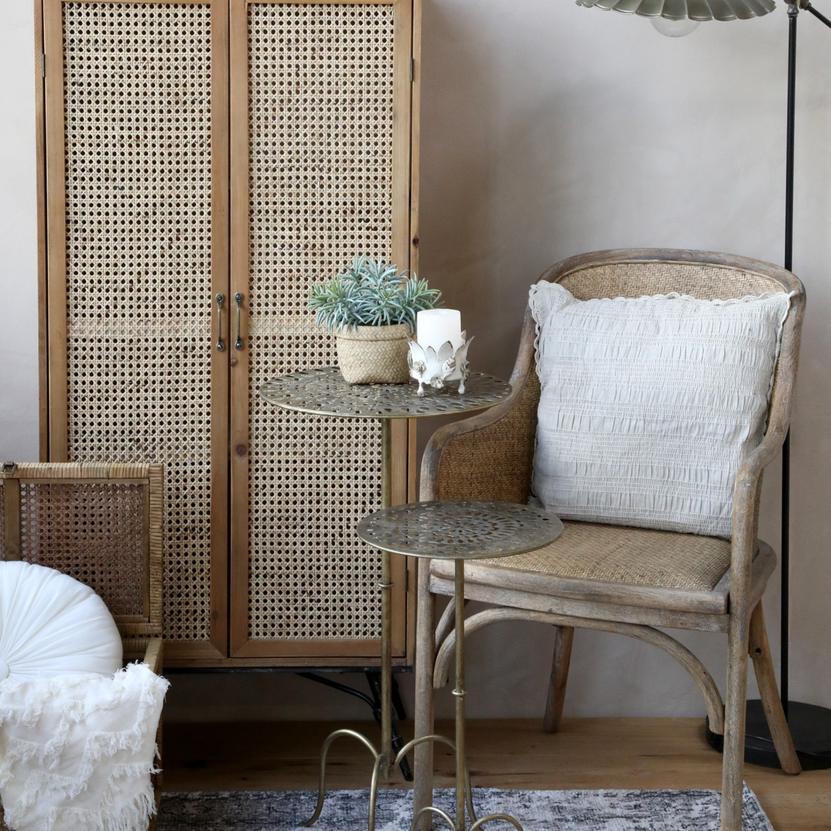 rattan dining chair with cushion and metal side tables.