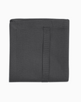 Dark grey kitchen towel folded up into a square.