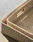Close up of rattan tray set stacked together.