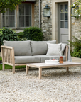 2 Seater Outdoor Sofa with cushions and coffee table in patio garden.