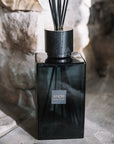 Sences Alang Alang Onyx Extra Large Reed Diffuser on stone hearth.