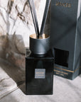 Sences Alang Alang Onyx Reed Diffuser on stone hearth.