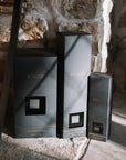 Set of three Onyx Diffuser Presentation boxes on stone hearth.