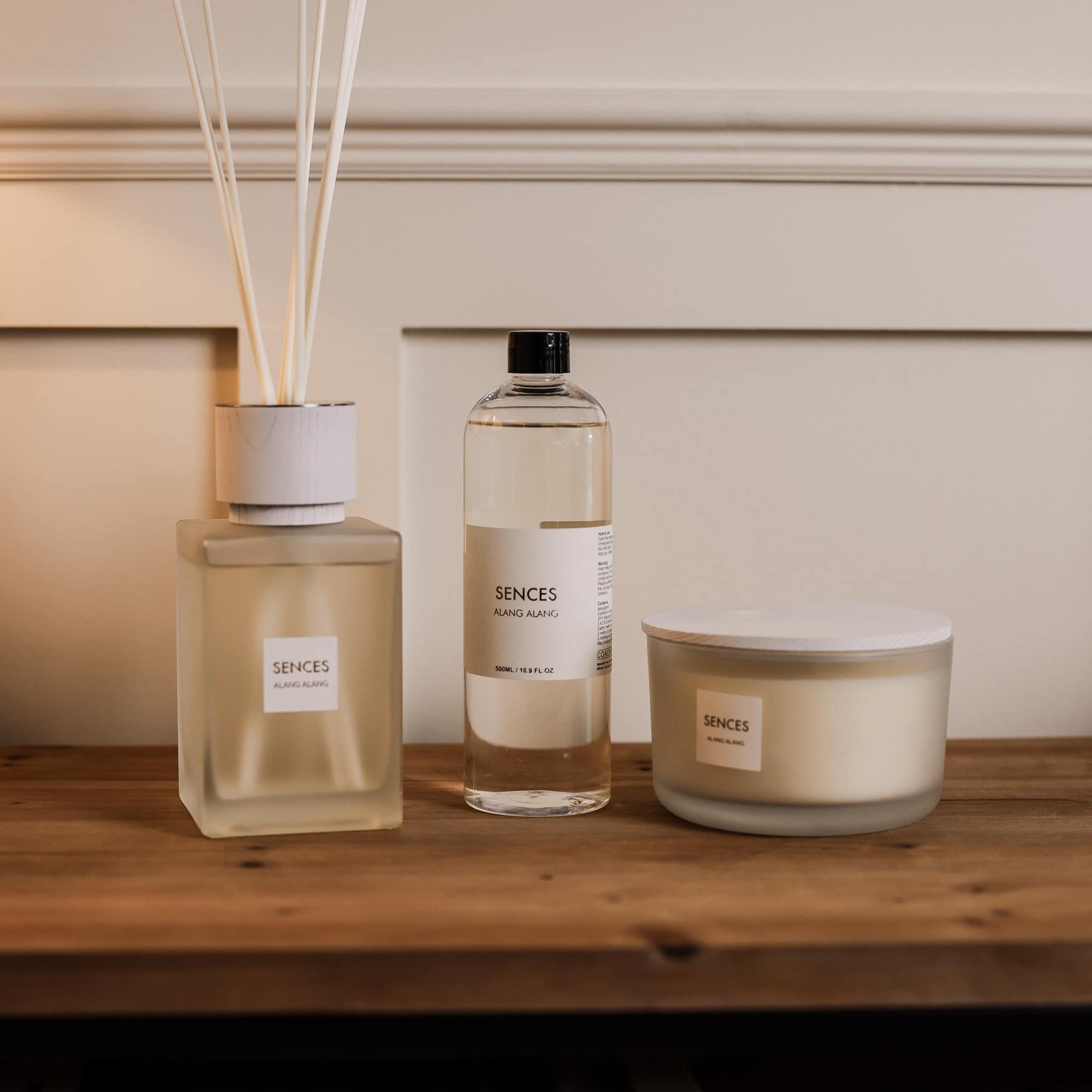Sences Alang Alang White Reed Diffuser with refill and candle on wooden console