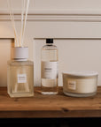 Sences Alang Alang White Reed Diffuser with refill and candle on wooden console