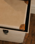 Set of two linen storage trunks with faux leather panelling.