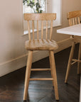 Three Farmhouse Bar Stools With Backs in dark wood kitchen.