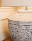 Close up of grey textured, distressed lamp.