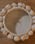 White ceramic bowl with decorative lemons, shot from above.