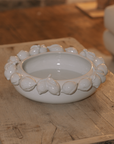 White ceramic bowl with decorative lemons on coffee table.