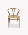Wishbone dining chairs with woven seat on a white background