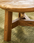 Close-up of round wooden table on a green carpet