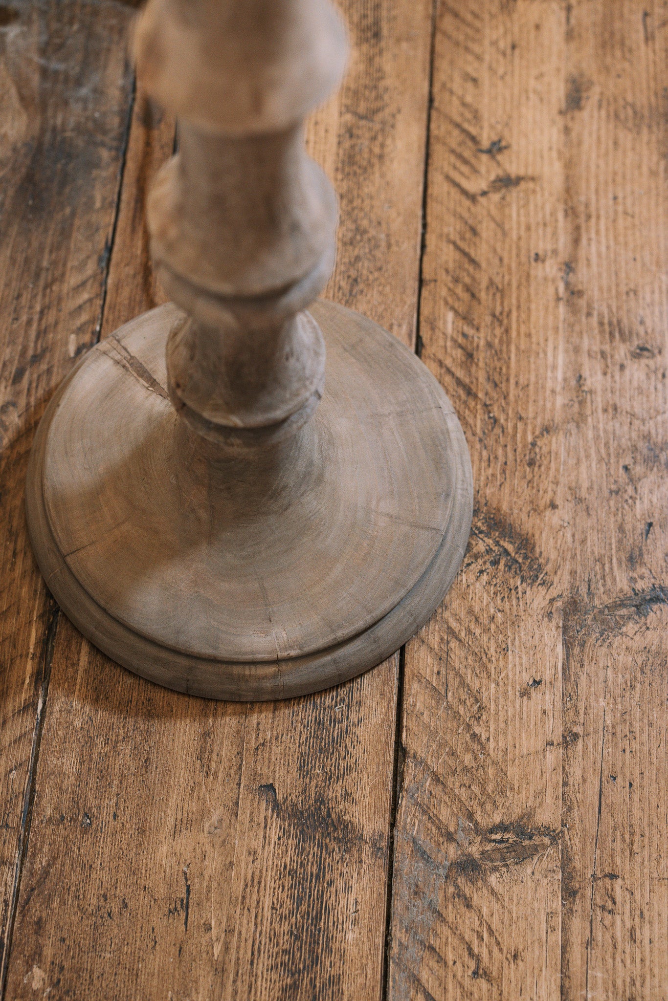 Bamboo look wooden floor lamp base on wooden floor.