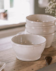 ceramic cereal bowls on wooden serving plank.