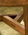 Close-up of a round wooden table with a blurred background