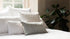 Neutral cushions on bed