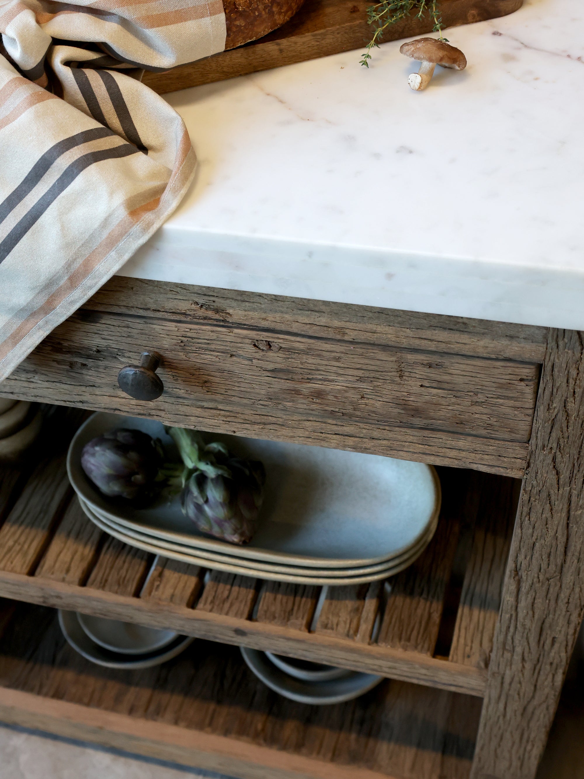 Wooden butchers block with marble top, close up of shelving.