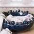 Blue ceramic bobble bowl with white napkins and artichokes. 
