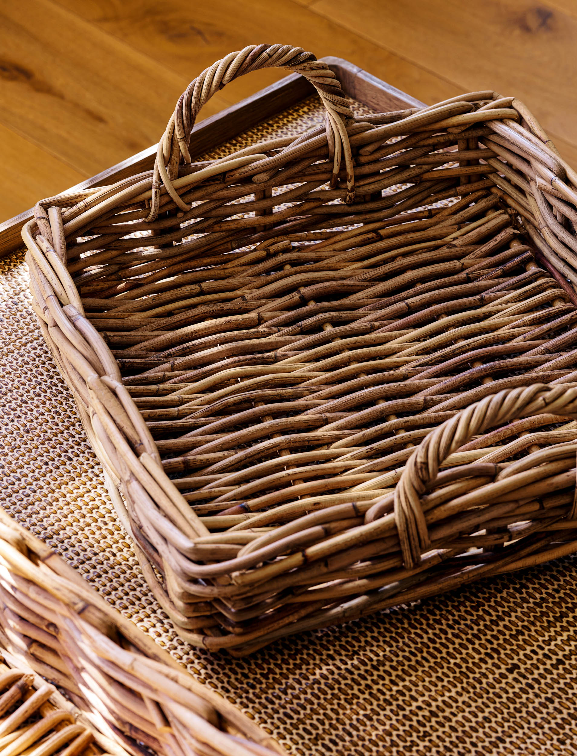 Natural woven trays on a wooden surface