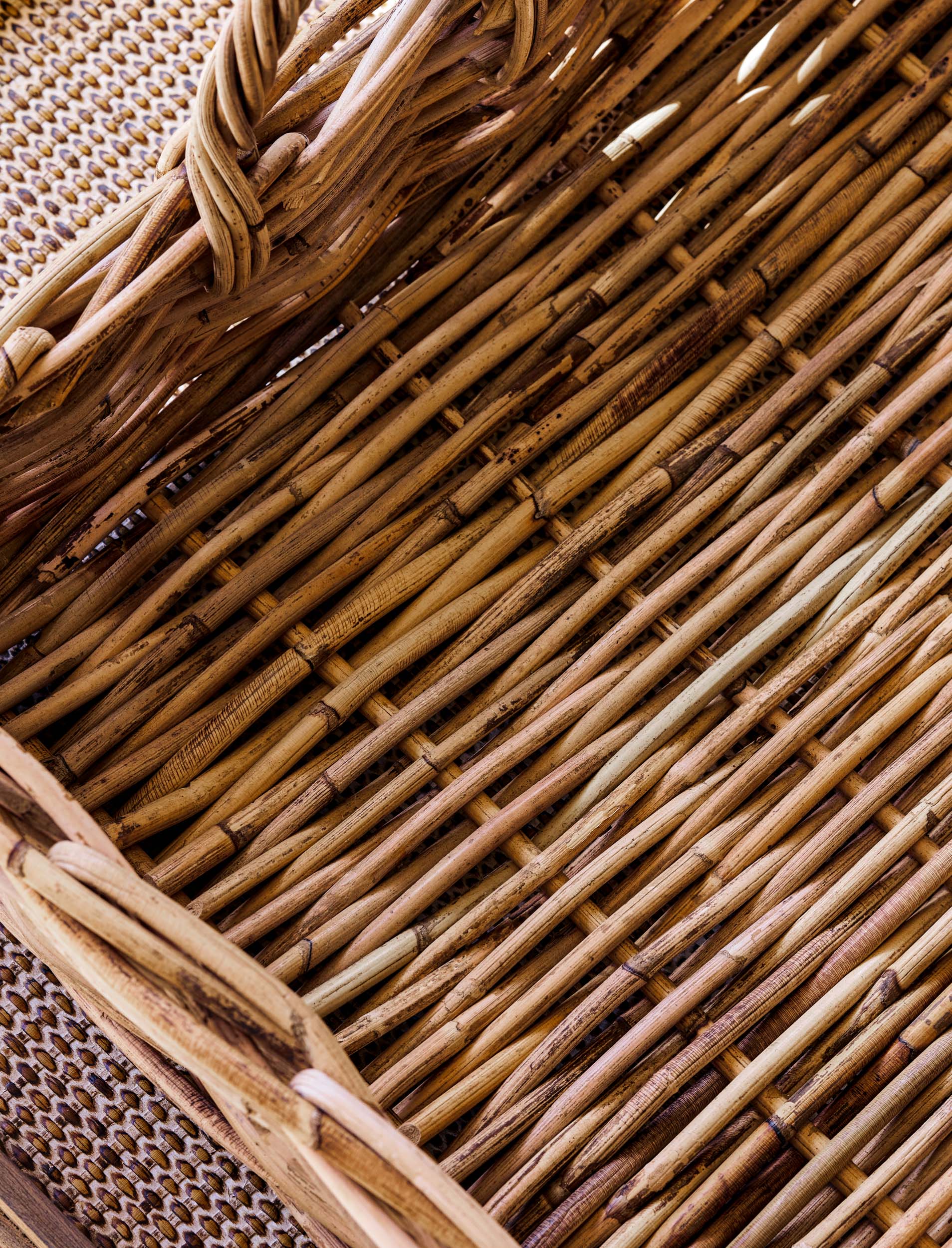 Close-up of natural woven trays with a focus on the texture and pattern of the wicker.