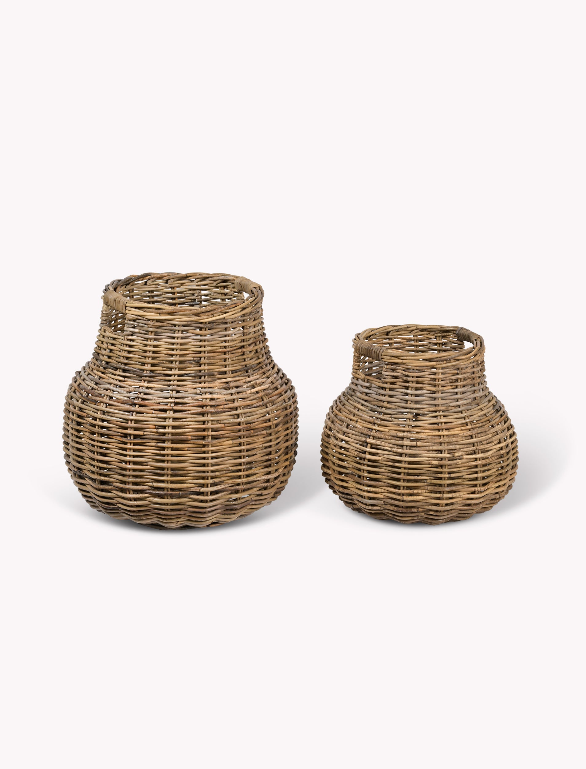 Two rattan storage baskets on a white background