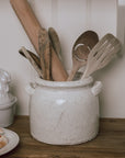 Belle Ceramic Utensil Holder on wooden chopping board with wooden utensils.