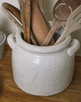 Belle Ceramic Utensil Holder on wooden chopping board with wooden utensils.