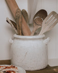 Belle Ceramic Utensil Holder on wooden chopping board with wooden utensils.