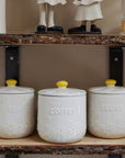 Daisy Tea coffee sugar canisters on wooden shelf