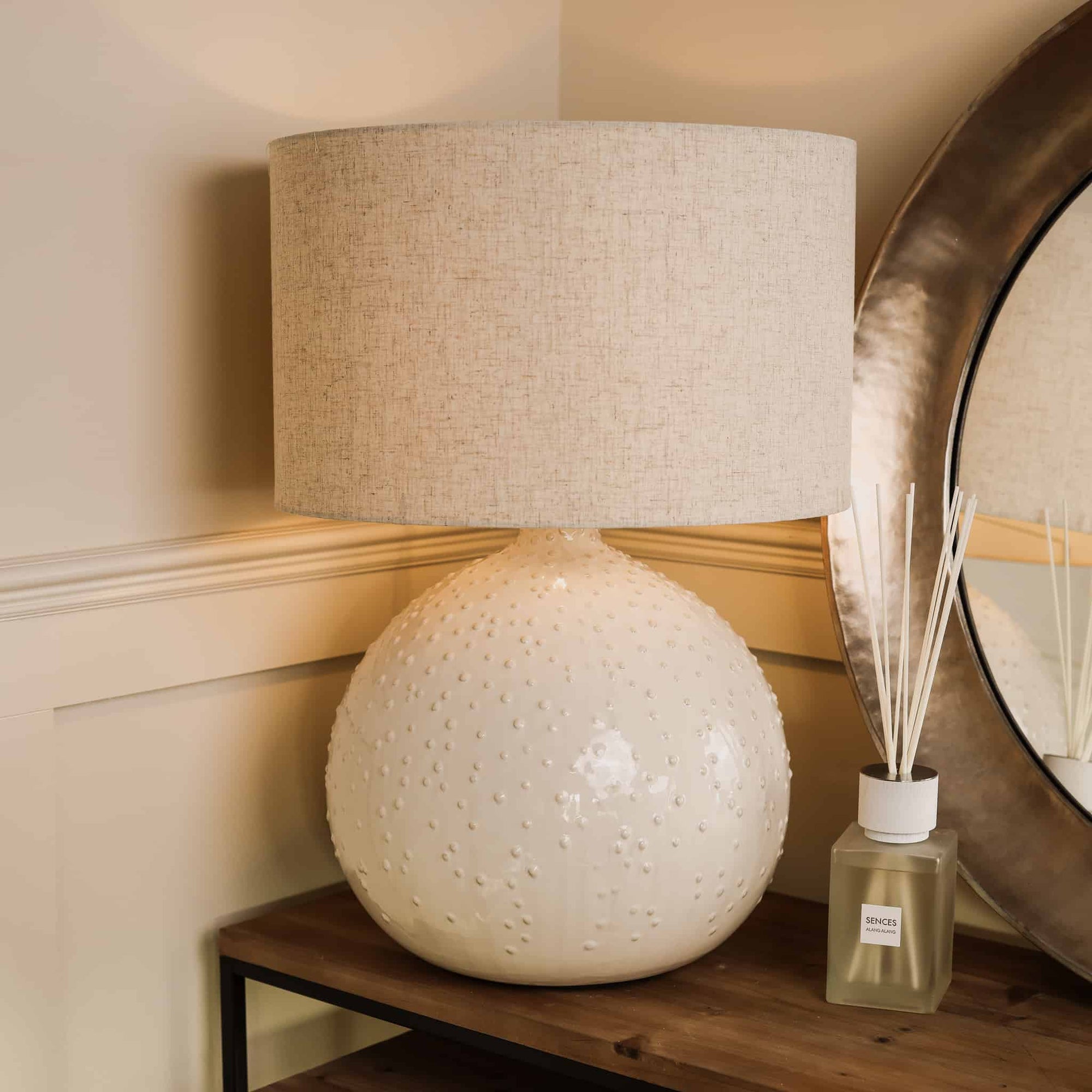 White textured ceramic table lamp with a clear diffuser. 