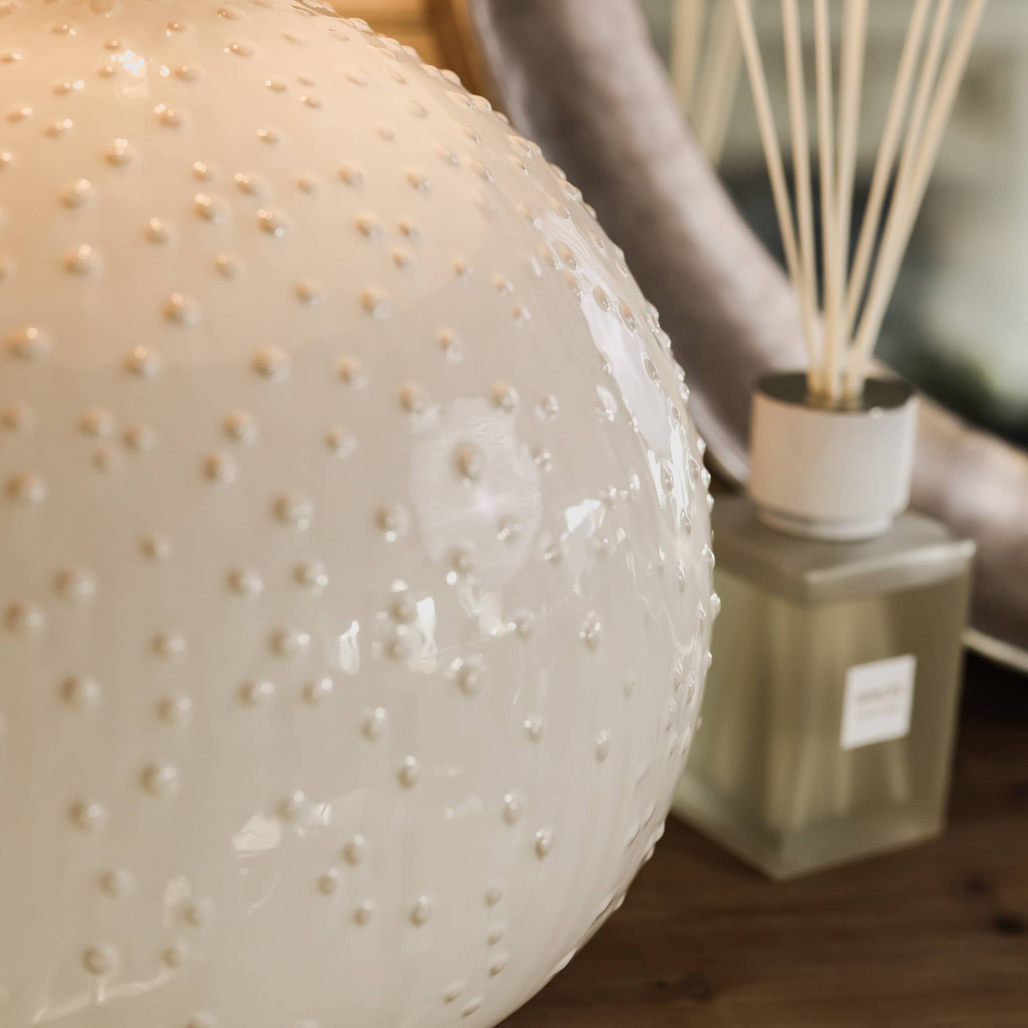 Close up of glazed textured white ceramic table lamp.