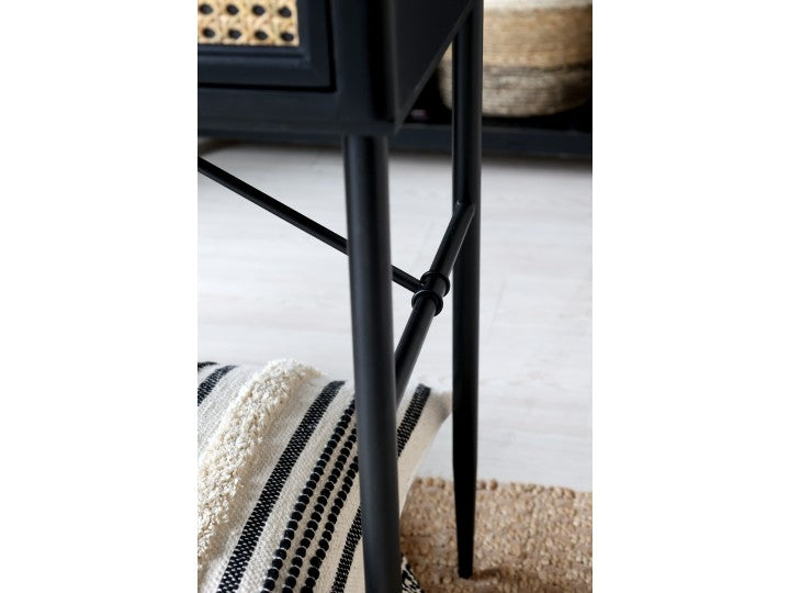 Black legs on wooden desk with drawers.