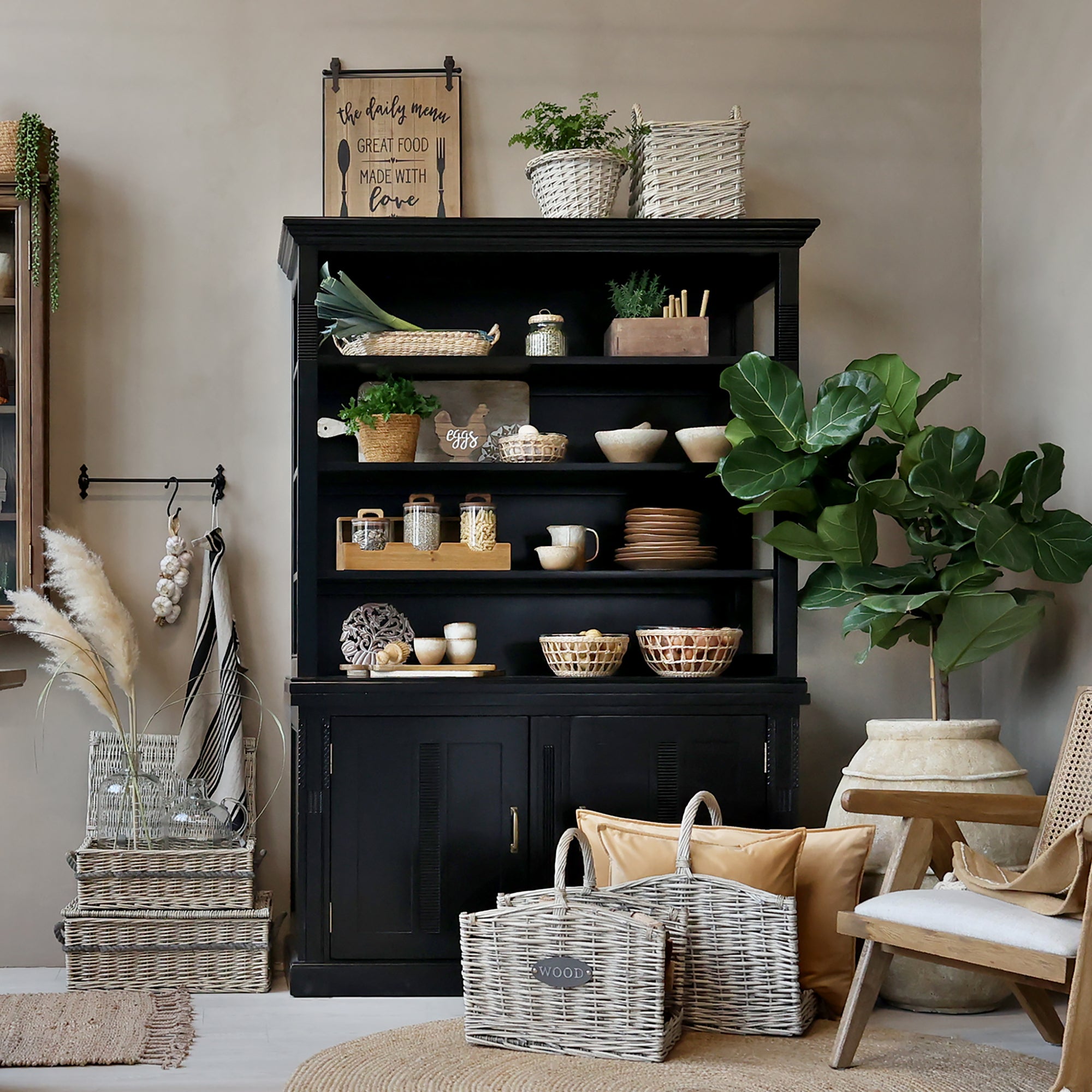 Black shelving unit filled with kitchen crockery, pantry items and farmhouse accessories.