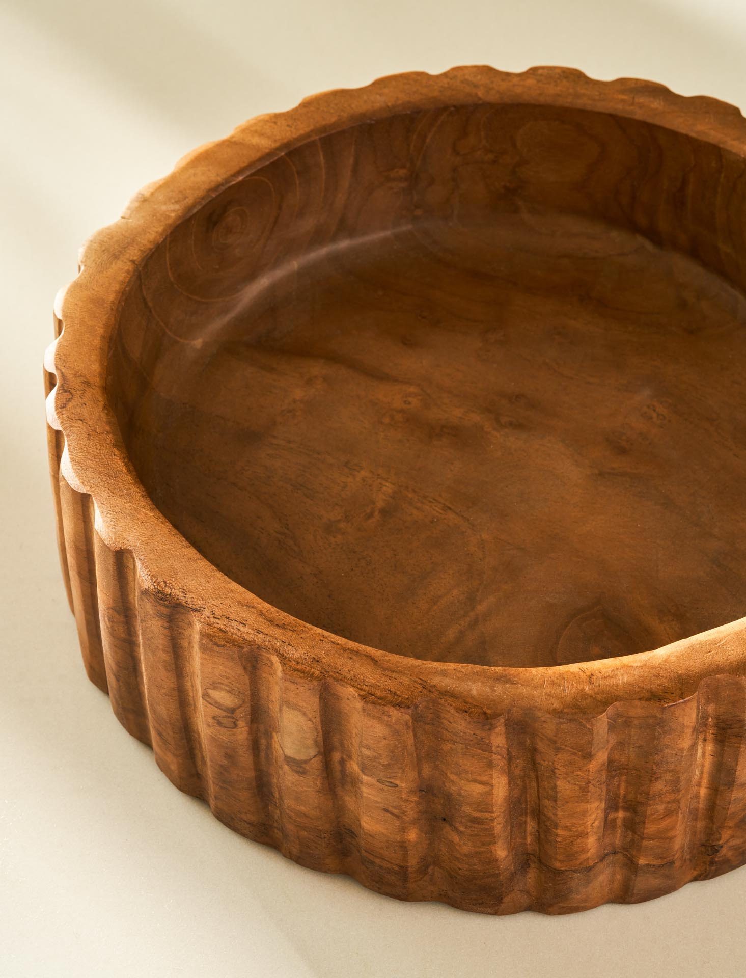 Wooden bowl with decorative rim on a white background