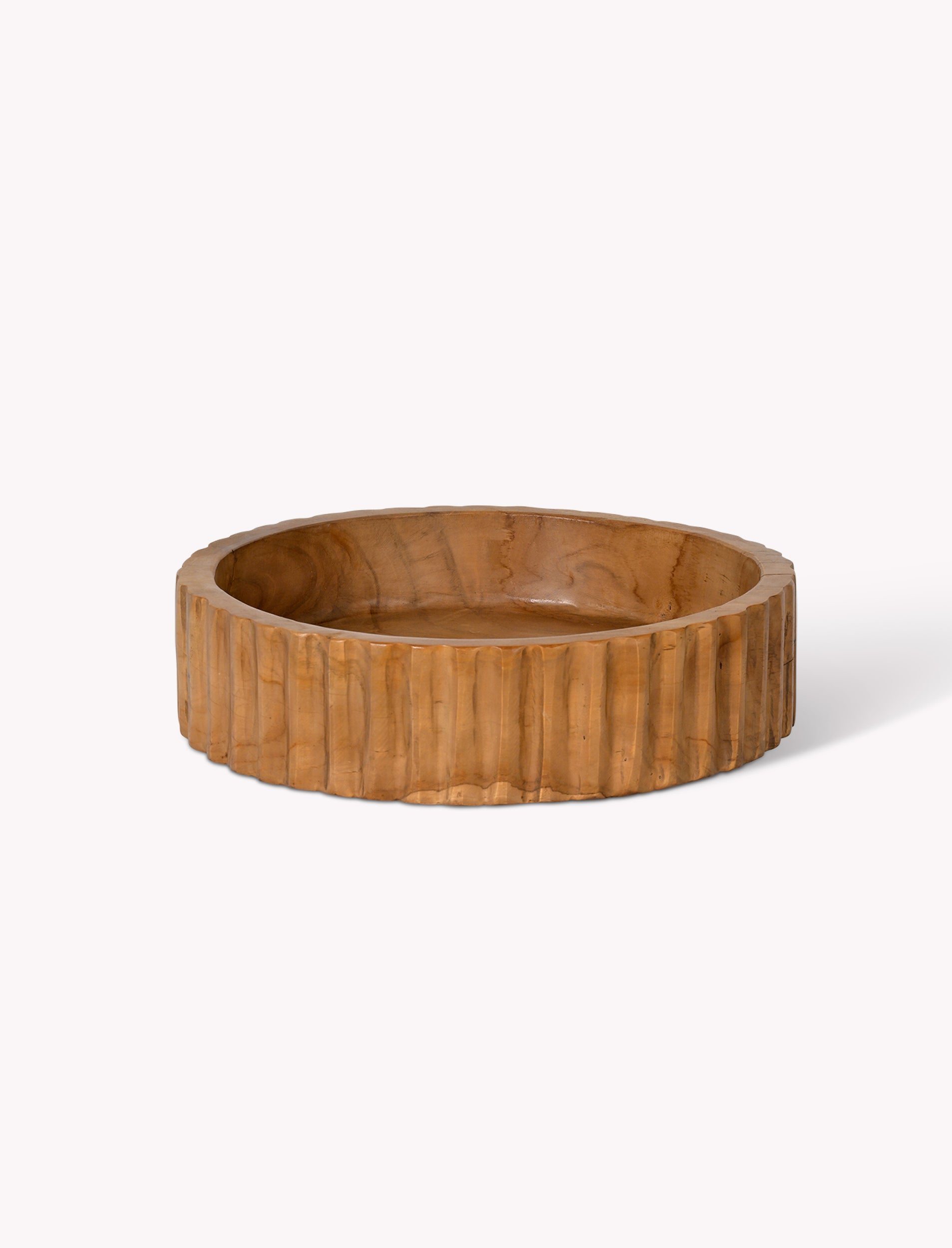 Wooden bowl with a ribbed texture on a white background