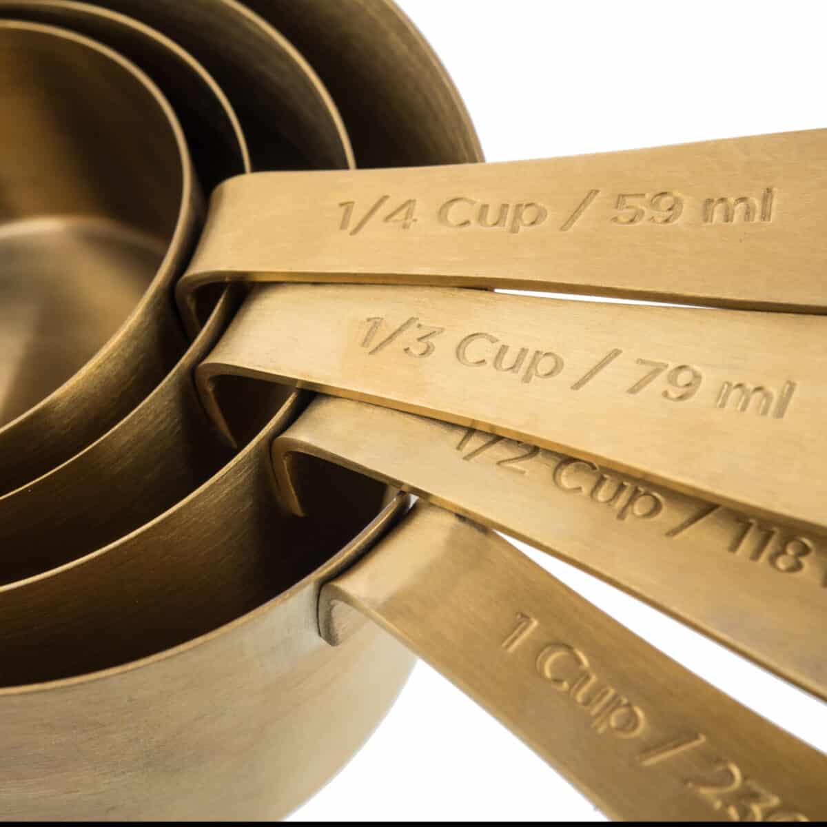 brass measuring cups embossed with measurements. 