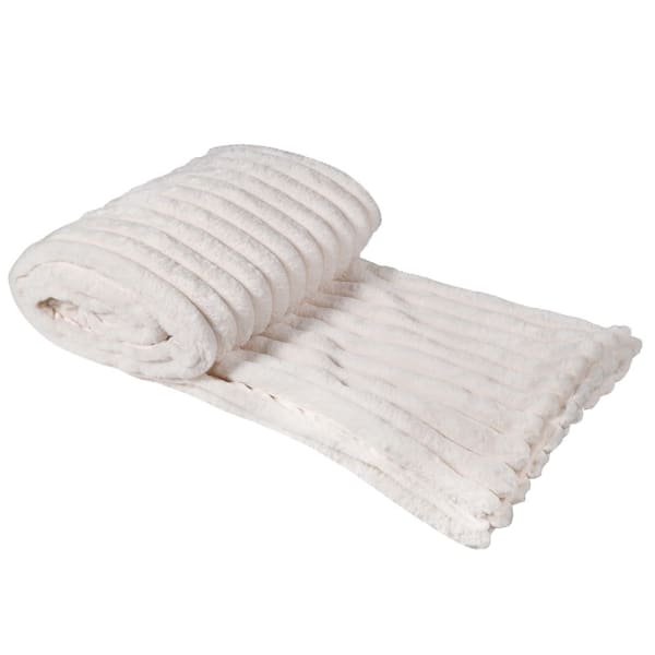 Cream faux fur throw rolled up.